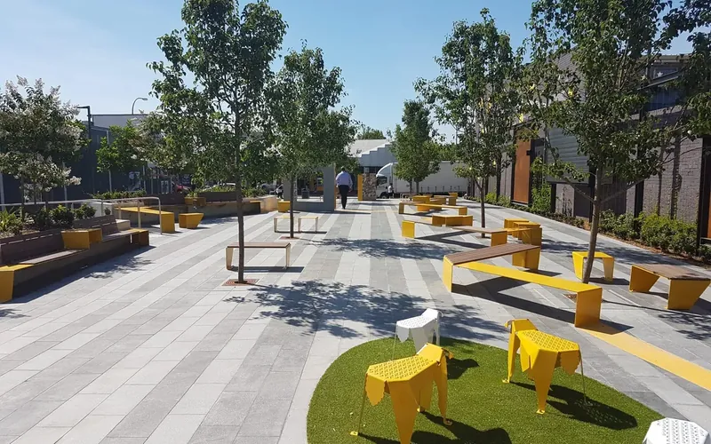 A pedestrian plaza with bench seating and trees in Fairfield.